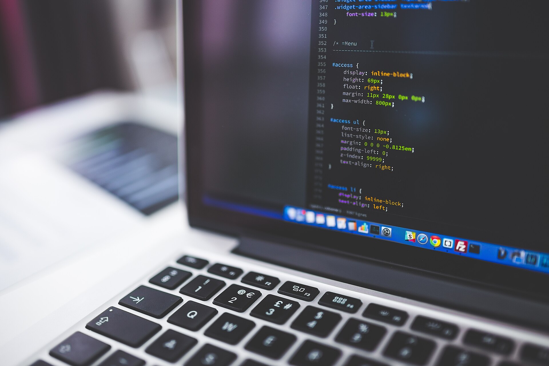 Close-up photograph of source code displayed on a laptop during programming work
